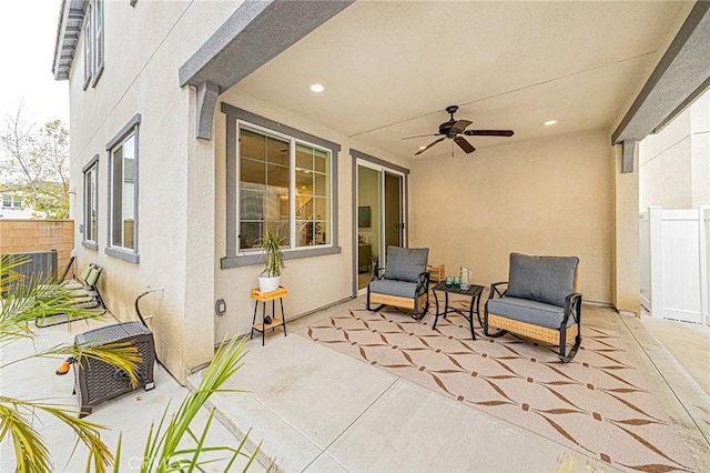 view of patio / terrace with ceiling fan and fence