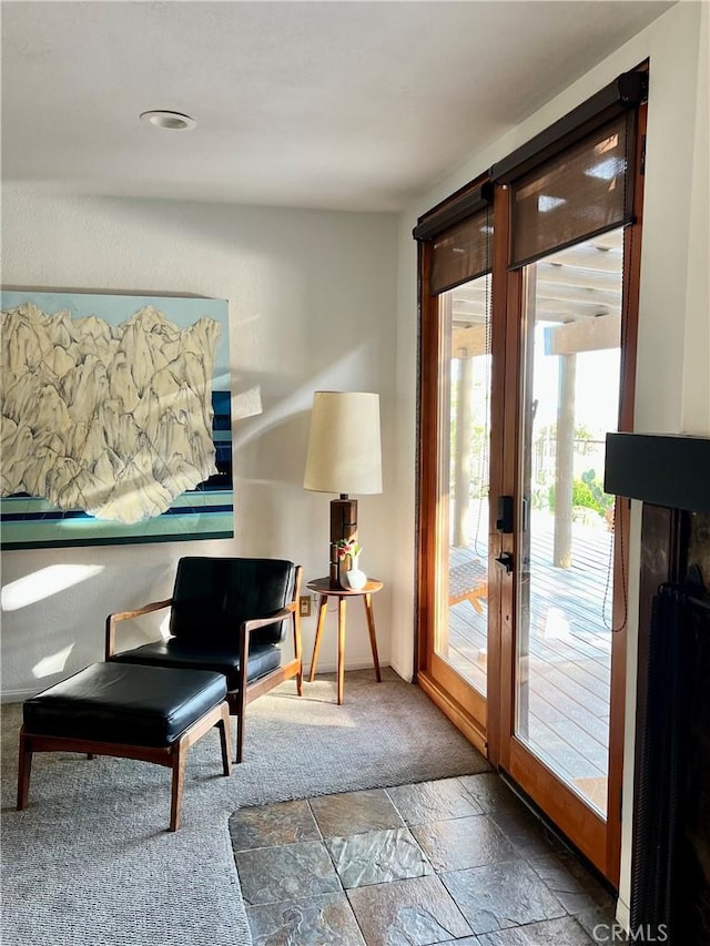 living area featuring stone tile flooring