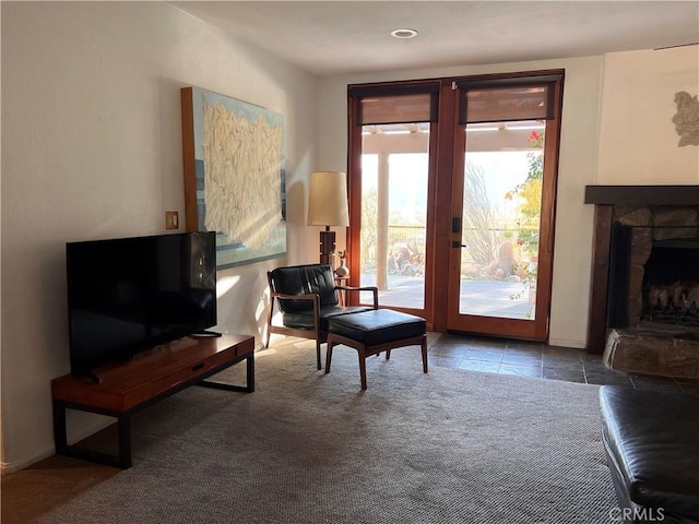 sitting room featuring carpet, a fireplace, and french doors