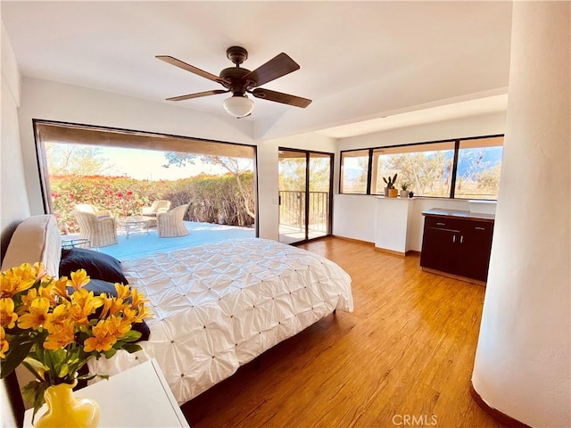 bedroom featuring light wood-style floors, access to exterior, and ceiling fan