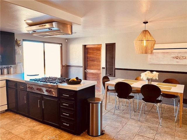 kitchen with light countertops, stainless steel gas stovetop, a peninsula, and exhaust hood