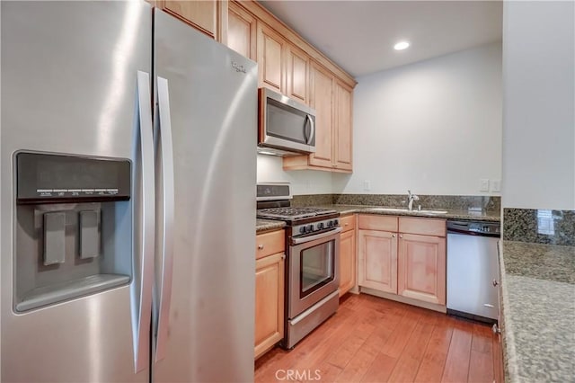 kitchen featuring light wood-style floors, light brown cabinets, stainless steel appliances, and recessed lighting