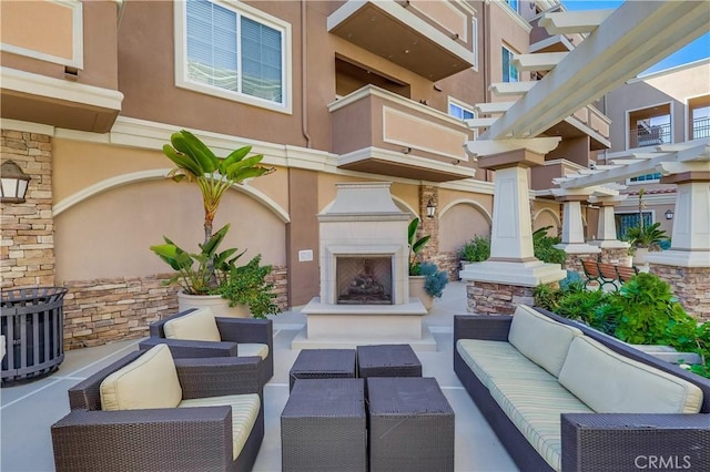 view of patio / terrace with an outdoor living space with a fireplace