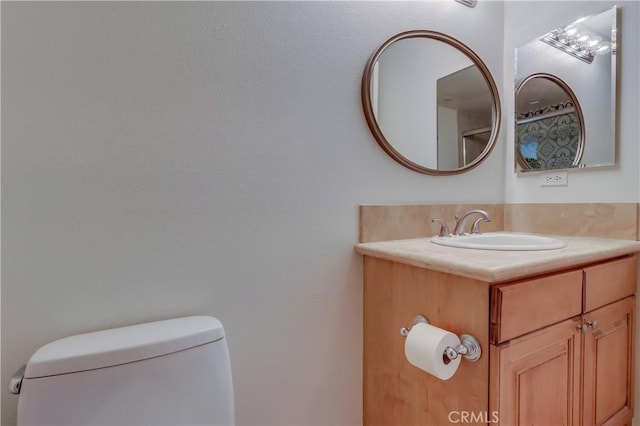 bathroom with toilet and vanity