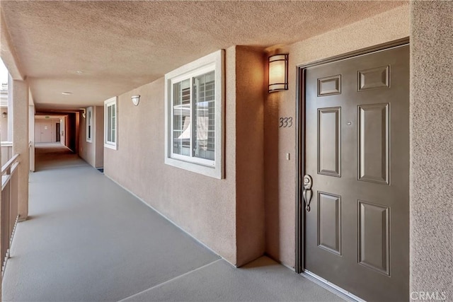 view of exterior entry with stucco siding