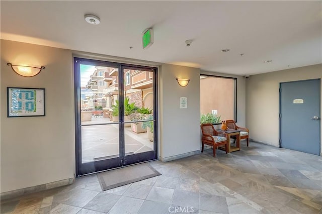 doorway featuring baseboards