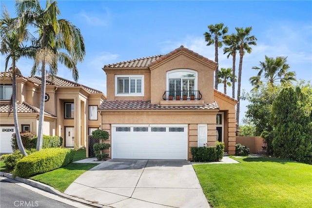 mediterranean / spanish-style home with driveway, stucco siding, a front lawn, a garage, and a tile roof