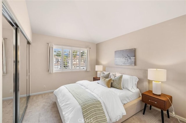 carpeted bedroom with baseboards and a closet