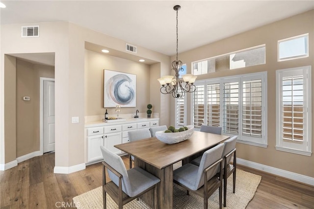 dining area featuring visible vents, baseboards, and light wood-style flooring