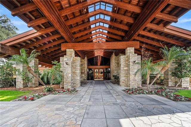 exterior space featuring french doors and stone siding