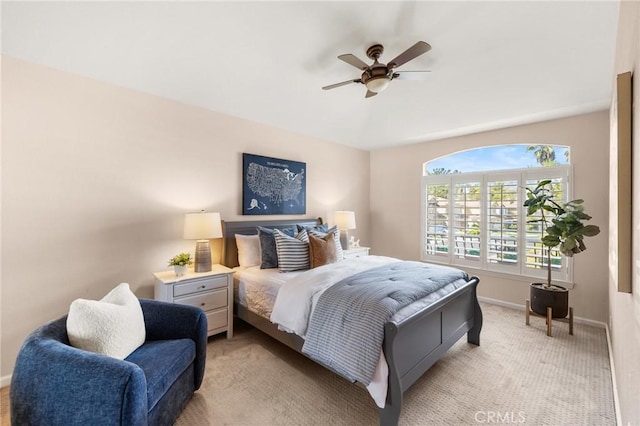 bedroom featuring light carpet, ceiling fan, and baseboards