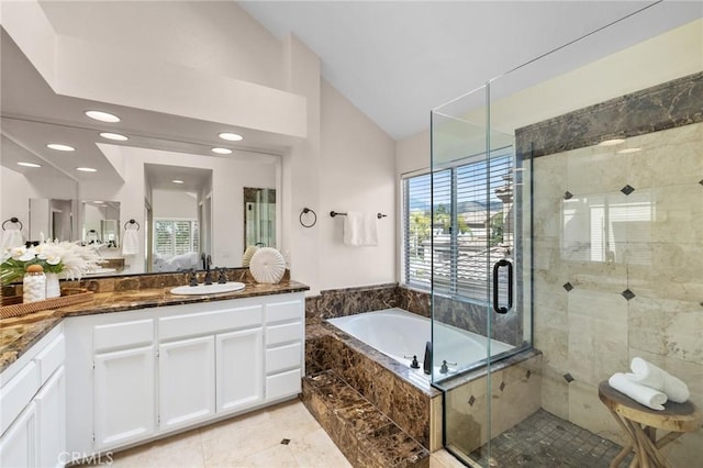 ensuite bathroom with vanity, recessed lighting, a stall shower, vaulted ceiling, and a bath