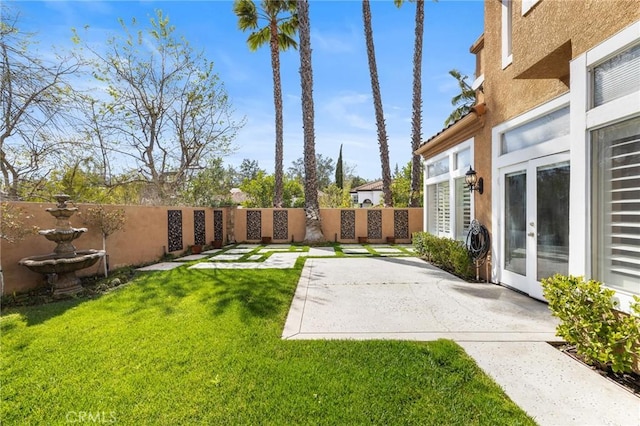 view of yard with french doors, a patio, and fence