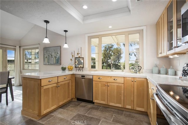 kitchen featuring a peninsula, pendant lighting, stainless steel appliances, and light countertops