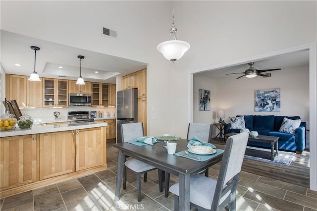dining area featuring visible vents, ceiling fan, recessed lighting, and a tray ceiling