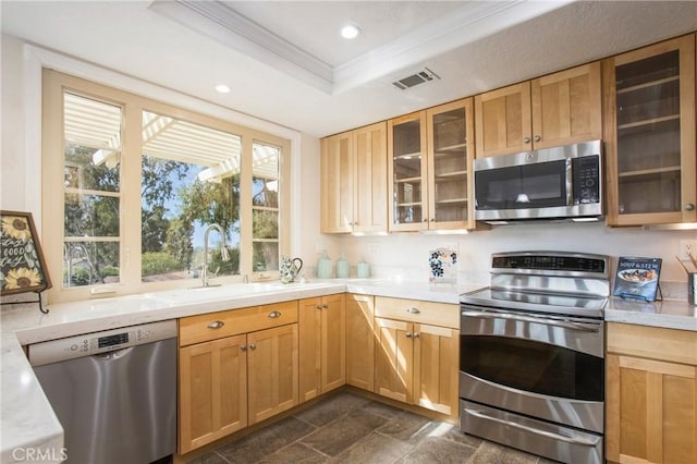 kitchen with a tray ceiling, crown molding, recessed lighting, visible vents, and appliances with stainless steel finishes