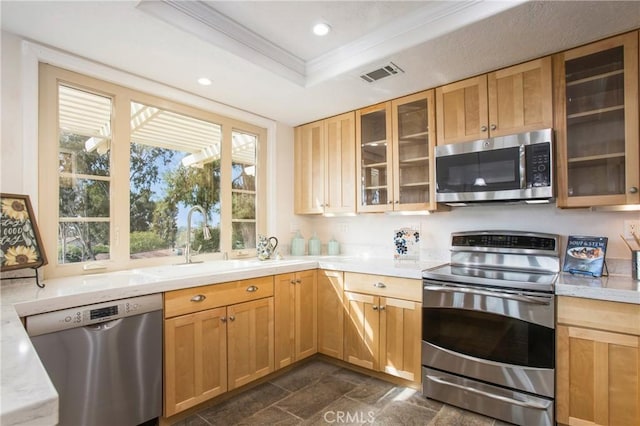 kitchen featuring appliances with stainless steel finishes, stone finish flooring, visible vents, a tray ceiling, and recessed lighting