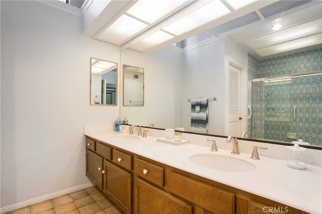 full bathroom with double vanity, a stall shower, a sink, and baseboards