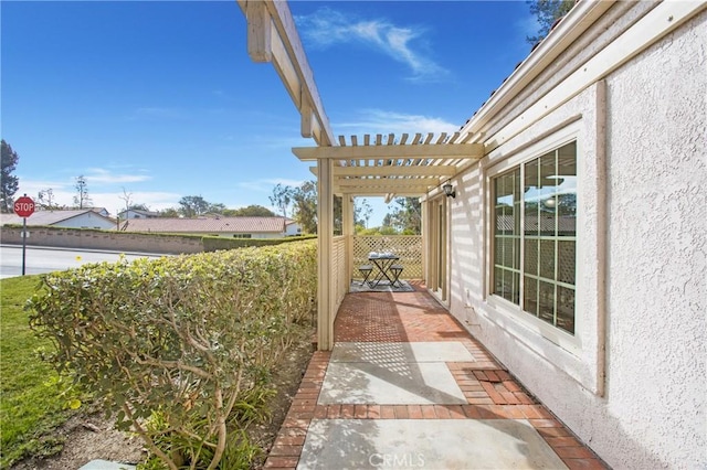 view of patio featuring fence and a pergola