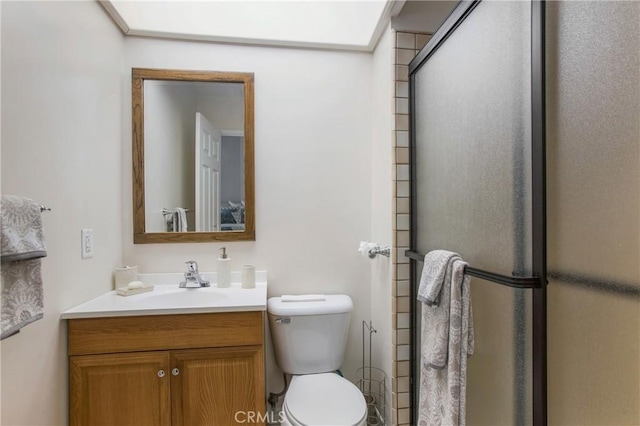 full bath featuring vanity, a shower stall, and toilet