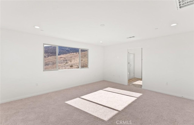 empty room featuring baseboards, visible vents, carpet flooring, and recessed lighting