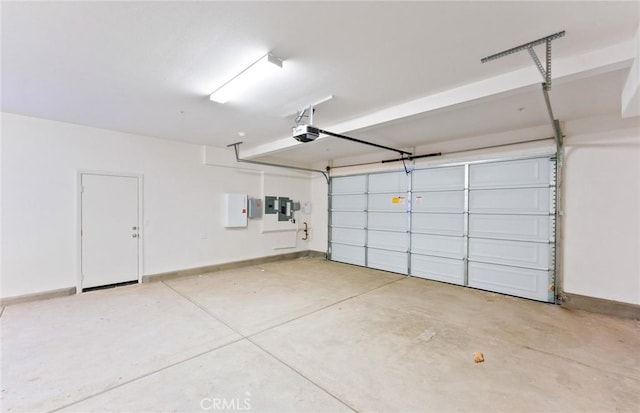 garage with a garage door opener and baseboards