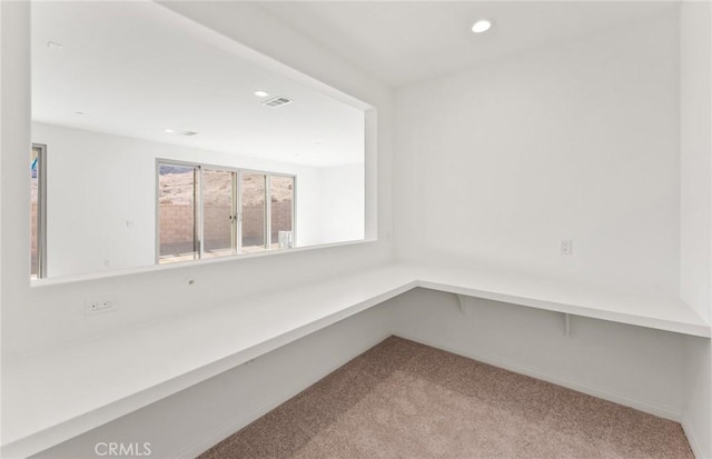 carpeted spare room featuring recessed lighting, visible vents, and baseboards