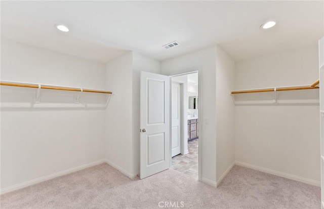 walk in closet featuring carpet and visible vents