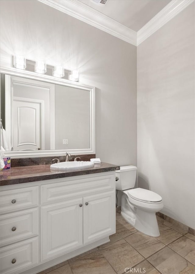 half bathroom with toilet, ornamental molding, and vanity