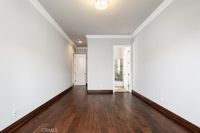 empty room with ornamental molding, dark wood finished floors, and baseboards