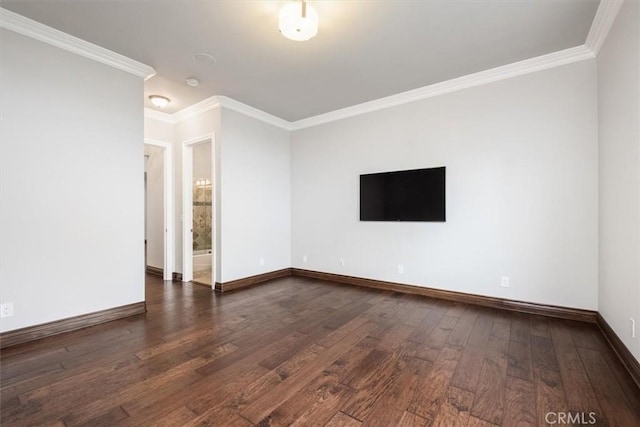 empty room with crown molding, dark wood-type flooring, and baseboards