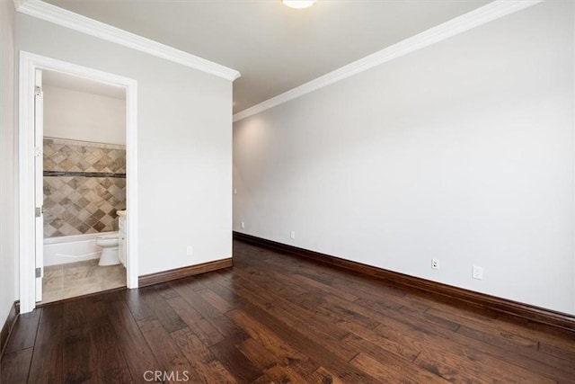 unfurnished bedroom featuring ornamental molding, ensuite bathroom, baseboards, and wood finished floors