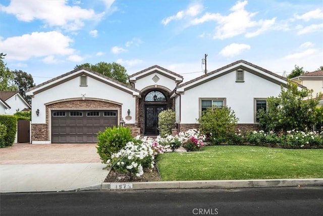 4976 Odessa Ave, Encino, CA 91436 - view of front of house featuring a front lawn, stucco siding, stone siding, decorative driveway, and an attached garage