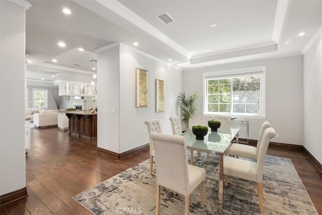 4976 Odessa Ave, Encino, CA 91436 - dining area featuring baseboards, visible vents, dark wood-type flooring, and a tray ceiling