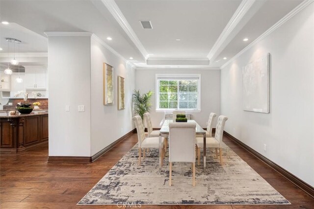 4976 Odessa Ave, Encino, CA 91436 - dining area with a raised ceiling, dark wood-type flooring, visible vents, baseboards, and ornamental molding