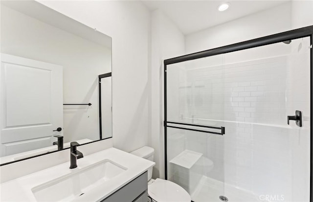 full bathroom featuring toilet, a shower stall, recessed lighting, and vanity