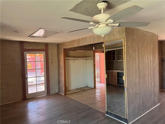 unfurnished bedroom featuring a closet, visible vents, ceiling fan, and wood finished floors