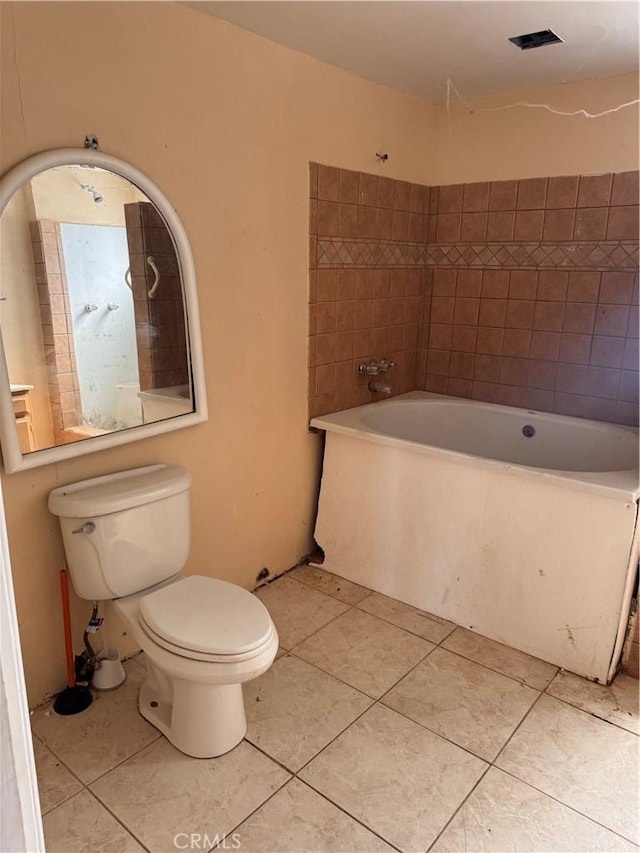 full bath with tile patterned flooring, toilet, and a washtub