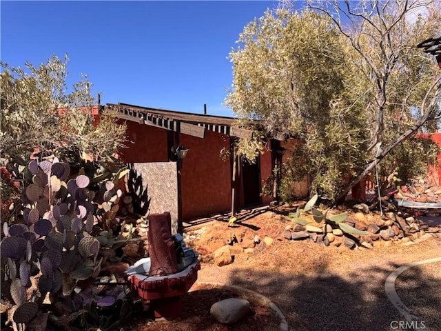 view of side of home with stucco siding