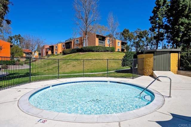 view of swimming pool with a pool, a residential view, fence, and a lawn