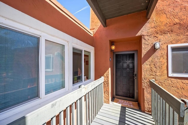 entrance to property with stucco siding