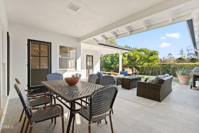 view of patio / terrace with outdoor dining area, an outdoor hangout area, and fence