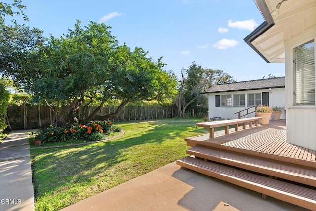 view of yard featuring a deck and fence