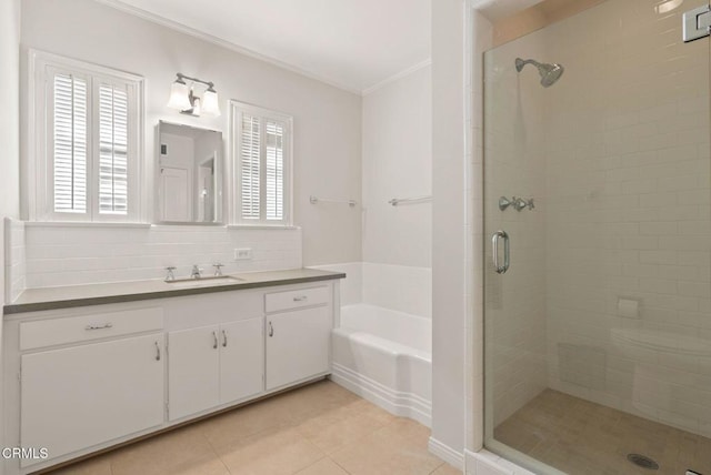 bathroom featuring a garden tub, a healthy amount of sunlight, a stall shower, and crown molding