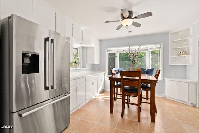 dining space featuring light tile patterned floors, a healthy amount of sunlight, and baseboards