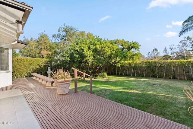 wooden deck featuring a yard and fence