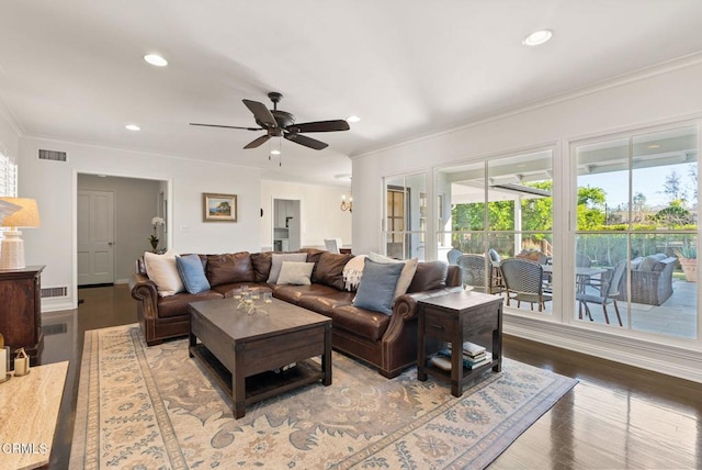 living room with wood finished floors, visible vents, recessed lighting, ornamental molding, and ceiling fan with notable chandelier