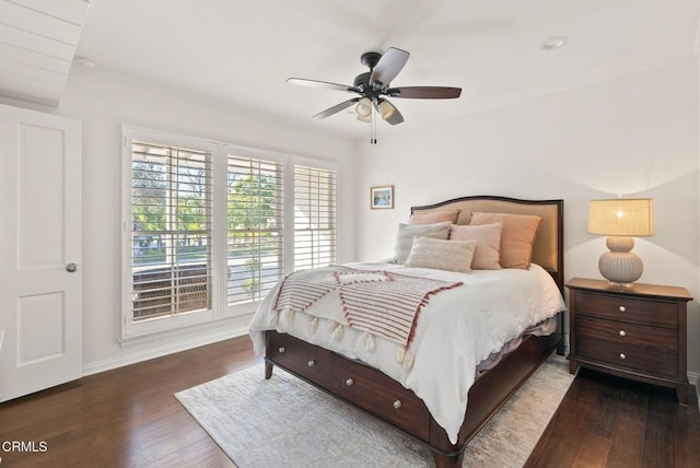 bedroom featuring ceiling fan, baseboards, and wood finished floors