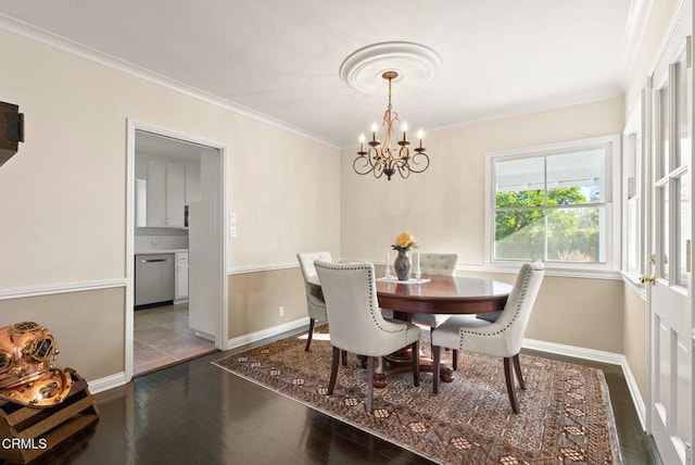 dining area with wood finished floors, baseboards, a chandelier, and ornamental molding