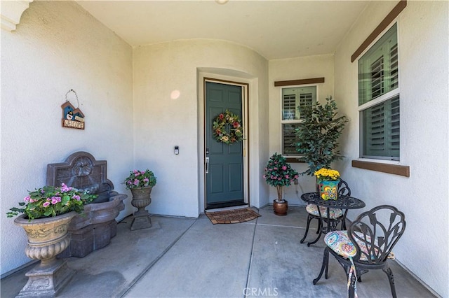 entrance to property featuring stucco siding